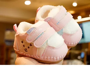 Detail of pink baby walker shoes with bear embroidery and soft fleece lining