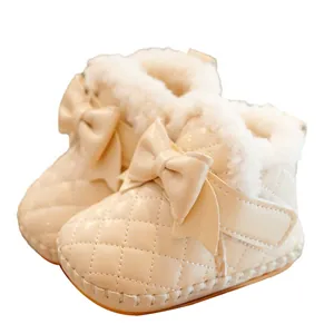 Quilted baby snow boots in beige with leather bow decoration and warm faux fur lining
