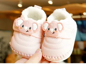 Detailed view of pink baby winter boots with thick plush lining and cute koala patch