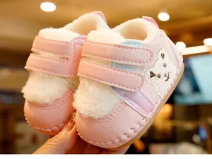 Close-up of pink baby walker shoe with warm plush lining and cute bear embroidery