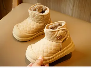 Close-up of quilted winter baby boots with warm fur lining and stylish gold buckle detail