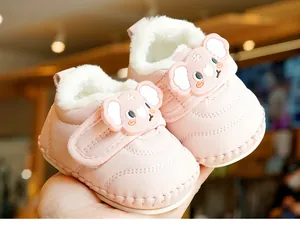Detail of pink baby winter boots with warm fleece lining and cute koala velcro strap