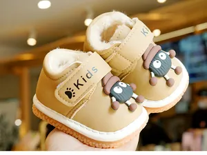 Close-up of warm winter baby shoes with thick fleece lining and cartoon mascot detail
