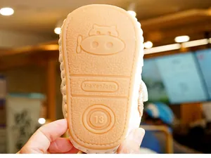 Detail view of anti-slip rubber baby shoe sole with embossed pattern and size marking