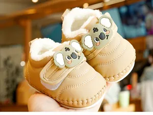 Detail of warm khaki baby winter boots with soft faux shearling lining and koala patch