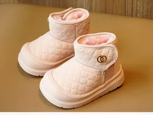 Detail view of pink quilted baby winter boots with warm plush lining and velcro strap