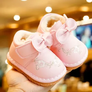 Pink fleece-lined baby walker shoes with flower embroidery and a soft non-slip sole