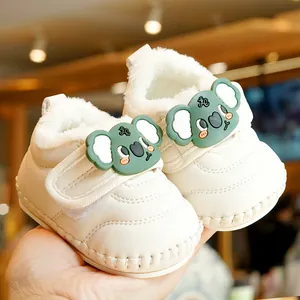 Soft-soled infant winter boots in off-white leather with plush lining and green koala