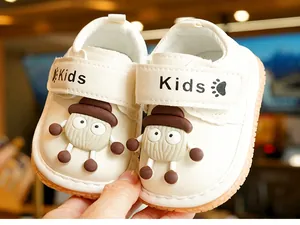 Close-up of white toddler shoes with soft anti-slip soles and velcro straps