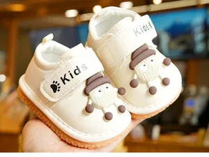 Close-up of baby walking shoes with cartoon lamb design and adjustable Velcro strap