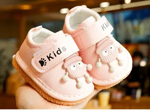 Close-up of pink toddler walking shoes featuring cartoon doll decor and non-slip rubber soles