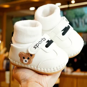 White baby walking shoes with brown bear embroidery and soft non-slip soles