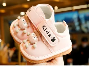 Detail of pink toddler shoes featuring non-slip rubber soles and cartoon octopus design