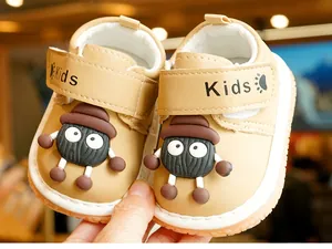Close-up of baby walking shoes with cartoon sprite decor and velcro strap detail