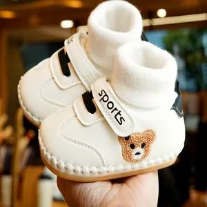 White baby walking shoes with cute bear embroidery and soft non-slip soles for infants