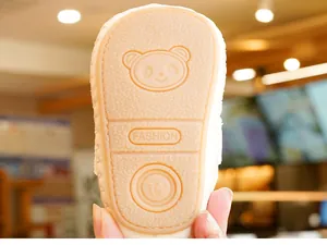 Detailed view of non-slip rubber sole with texture on beige baby walking shoes