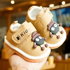 Khaki toddler shoes with non-slip rubber soles and cartoon character design