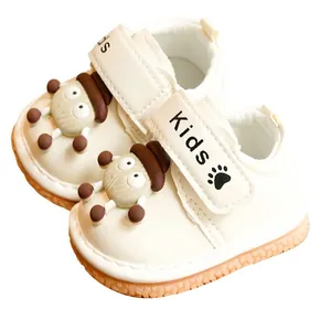 Cream toddler walking shoes with cartoon character and non-slip rubber soles