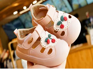 Detail of pink toddler sandal featuring cherry embroidery and soft anti-slip rubber sole