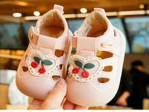Detail of pink toddler sandals featuring cute cherry embroidery and soft non-slip soles