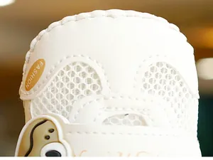 Detail of white infant walking shoe with breathable mesh and cute cartoon patch
