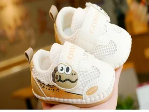 Detailed close-up of breathable mesh baby shoes with cute dinosaur patch and soft sole
