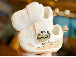 Detail of baby walker shoes featuring a cartoon dinosaur and breathable mesh material