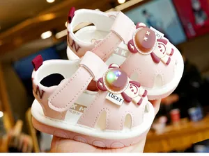 Detail of pink toddler sandals featuring an LED glowing bear and anti-slip rubber sole