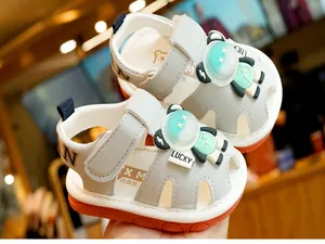 Detail of baby summer sandal with cartoon astronaut and flexible non-slip orange sole