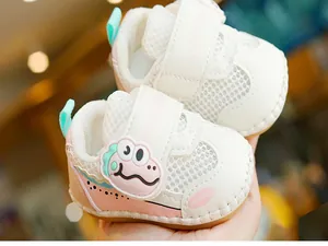 Close-up of baby mesh walking shoe featuring soft anti-slip rubber sole and cute 3D dinosaur