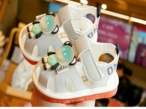Detail of toddler sandal featuring cartoon accent, breathable cutouts and secure strap