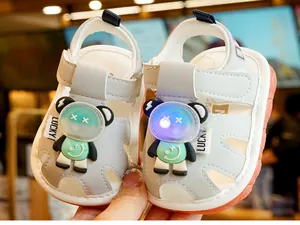 Close-up of baby walking sandals with a glowing LED cartoon panda on the toe cap