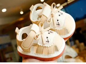 Detail of baby summer sandals featuring cute embroidered bear and non-slip soft soles