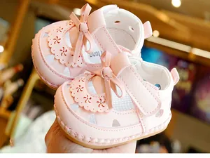 Detail of pink baby sandals with soft rubber sole and bow decoration for infant girls