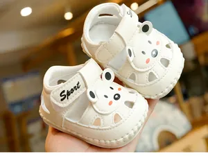 Detailed view of white baby sandals with cartoon bear and breathable hollow design