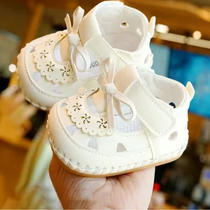 White baby girl summer sandals with soft non-slip soles and hollow floral patterns