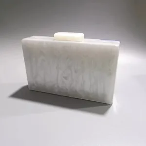 Detailed macro view of a white marble patterned acrylic clutch bag for elegant parties