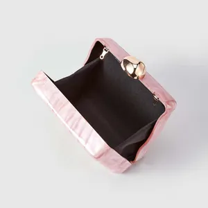 Detail of pink marble acrylic evening bag with gold sphere lock and black fabric lining