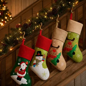 Set of four festive Christmas stockings with Santa and reindeer hanging on stairs
