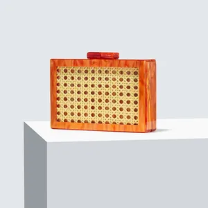 Detail of the amber acrylic frame and natural woven rattan panel on this evening clutch bag