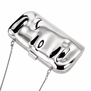 Detailed view of silver liquid metal clutch bag with unique wavy ripples and fine chain strap