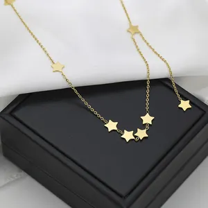 Polished gold titanium steel necklace with multiple star pendants on a black leather box
