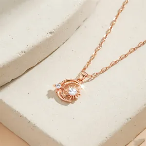 Rose gold celestial necklace with sparkling sun and moon zircon pendant on a fine chain