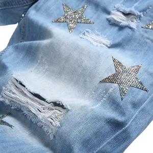 Light blue distressed denim shorts featuring rhinestone star embroidery and ripped details