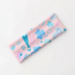 Detail of pink St. Patrick's Day elastic headband with shamrock and festive patterns