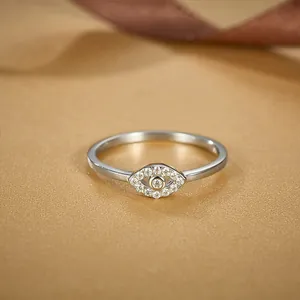 Elegant S925 sterling silver evil eye ring with sparkling pave crystals on champagne silk