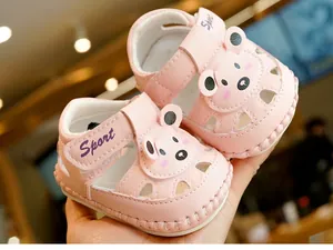 Detail of pink baby sandals with soft sole featuring cute cartoon bear and Sport strap