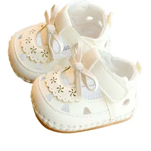 White baby girl sandals with bow decoration, hollow flower patterns and non-slip soft soles