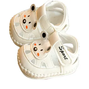 White baby sandals with cartoon bear design and soft anti-slip soles for infants