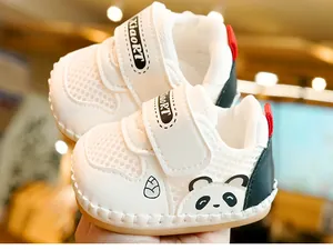Close-up of baby walking shoes with breathable white mesh and cute panda pattern